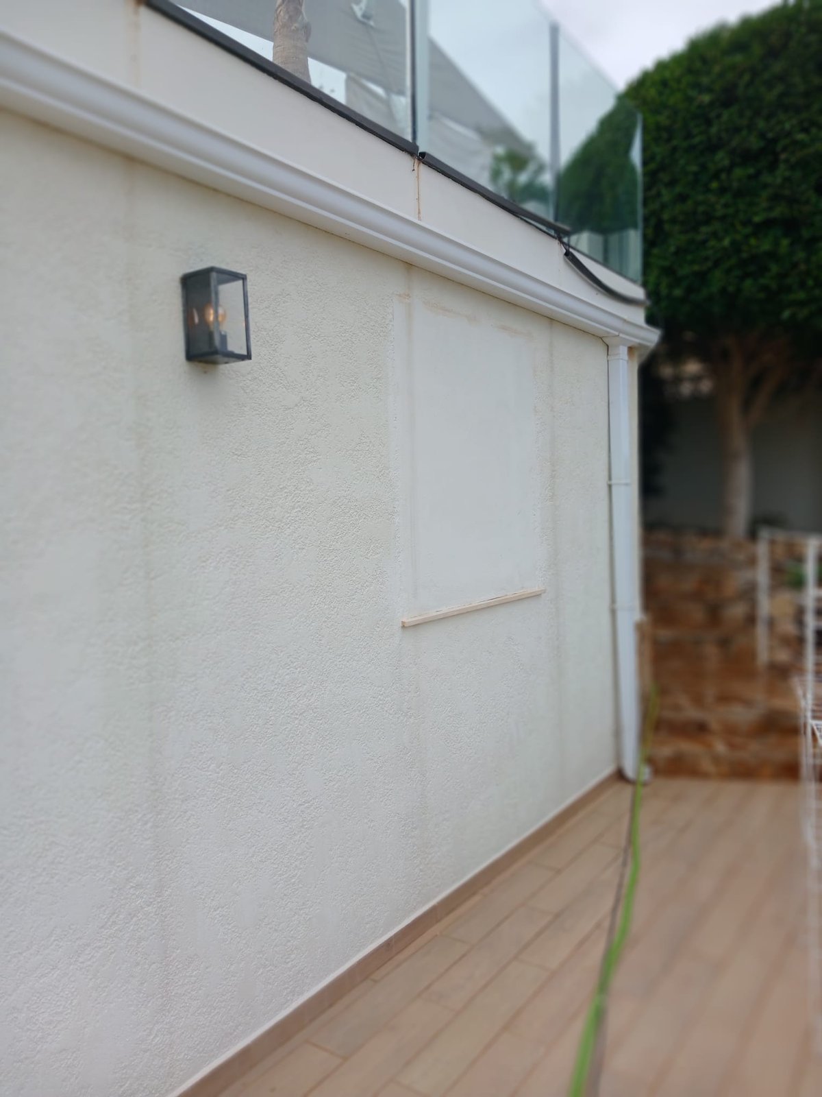 A patched and prepared section of exterior wall, ready for its final coat